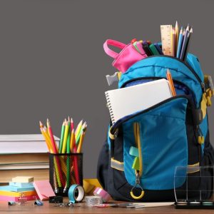 Backpack,With,Different,School,Stationery,On,Wooden,Table,Near,Blackboard,